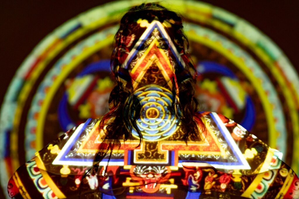 Meditating Woman Standing in front of a Projection