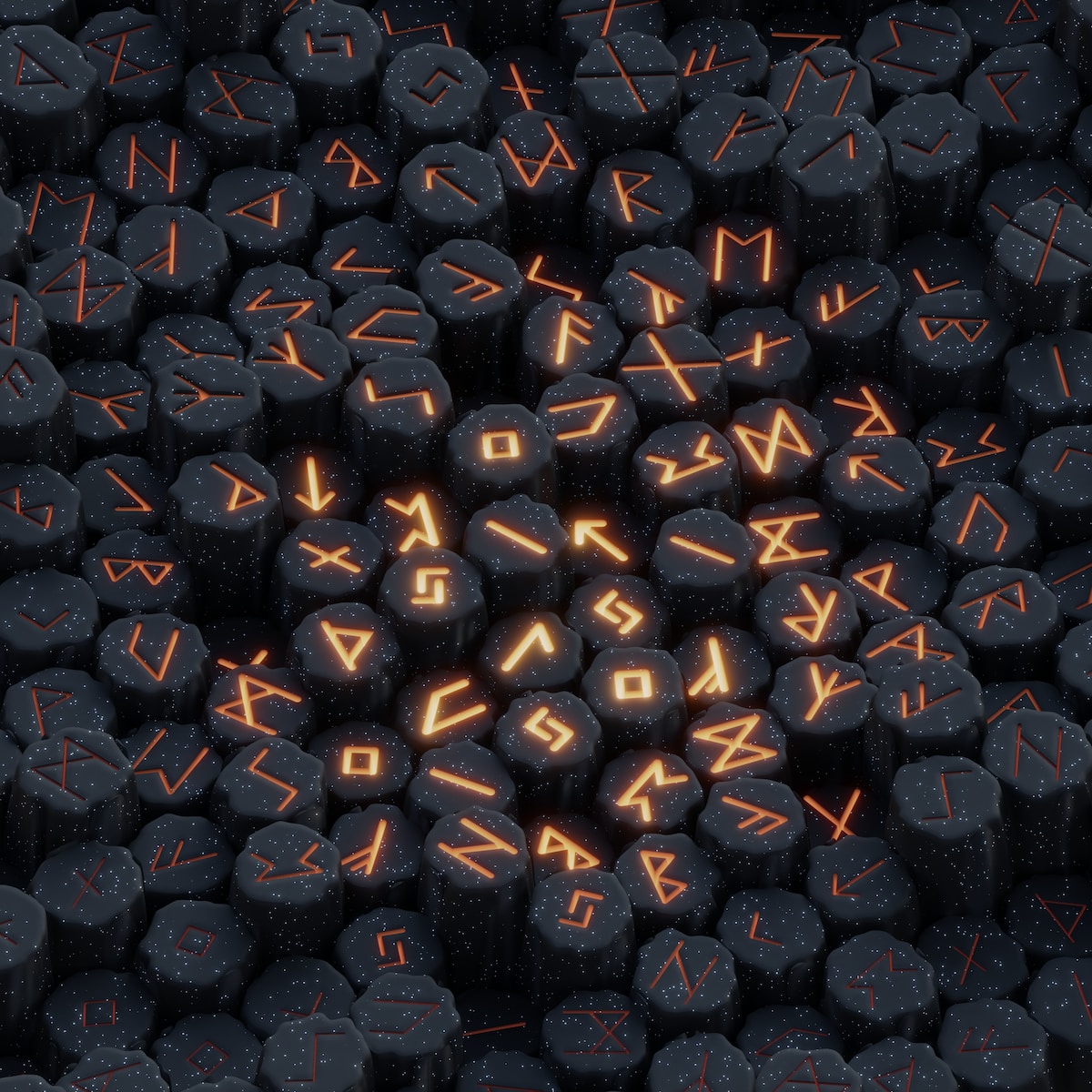 a pile of black rocks with orange letters on them